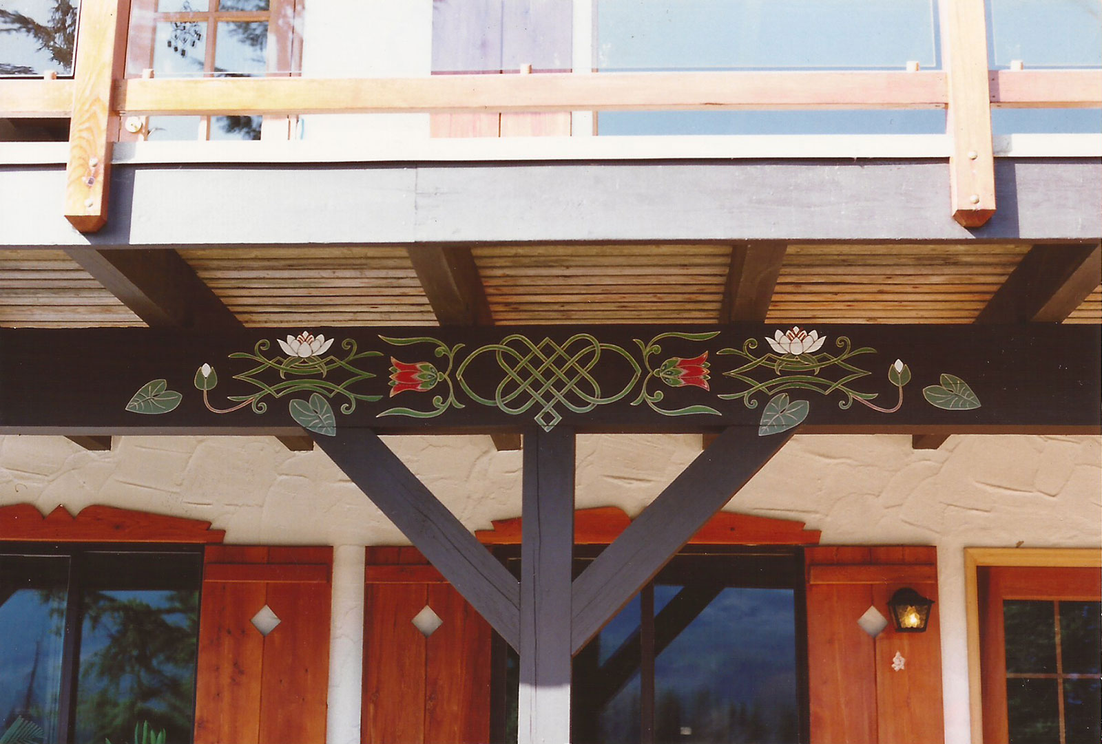 Beam paintings decorates this deck overlooking alpine meadows.  The deck faces the spectacular wetlands with many flowing water plants.